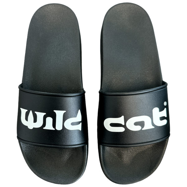 Sandalias Wildcat negras de PVC con logo blanco sobre fondo blanco