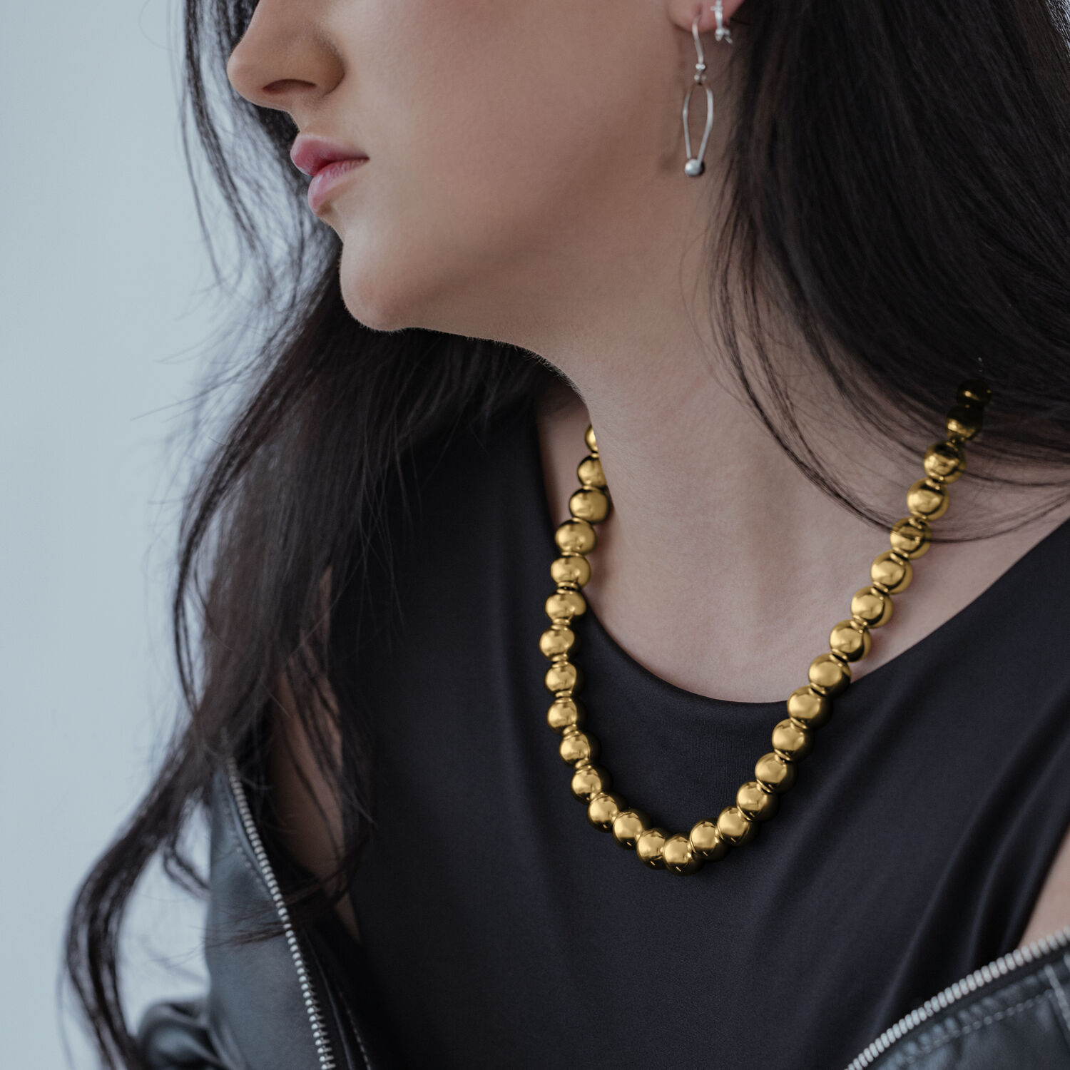 Mujer con top negro y collar burbuja dorado de Wildcat