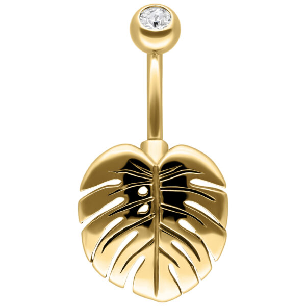 Piercing de ombligo dorado en forma de Monstera con cristal claro sobre fondo blanco