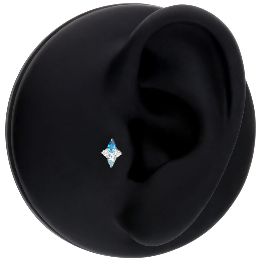Accesorio Push Fit plateado con cristal turquesa sobre fondo negro