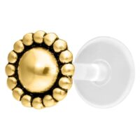Labret Push-Fit Piercing dorado con adorno redondo sobre fondo blanco