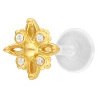 Labret dorado con diseño de estrella polar y piedras cristalinas sobre fondo blanco