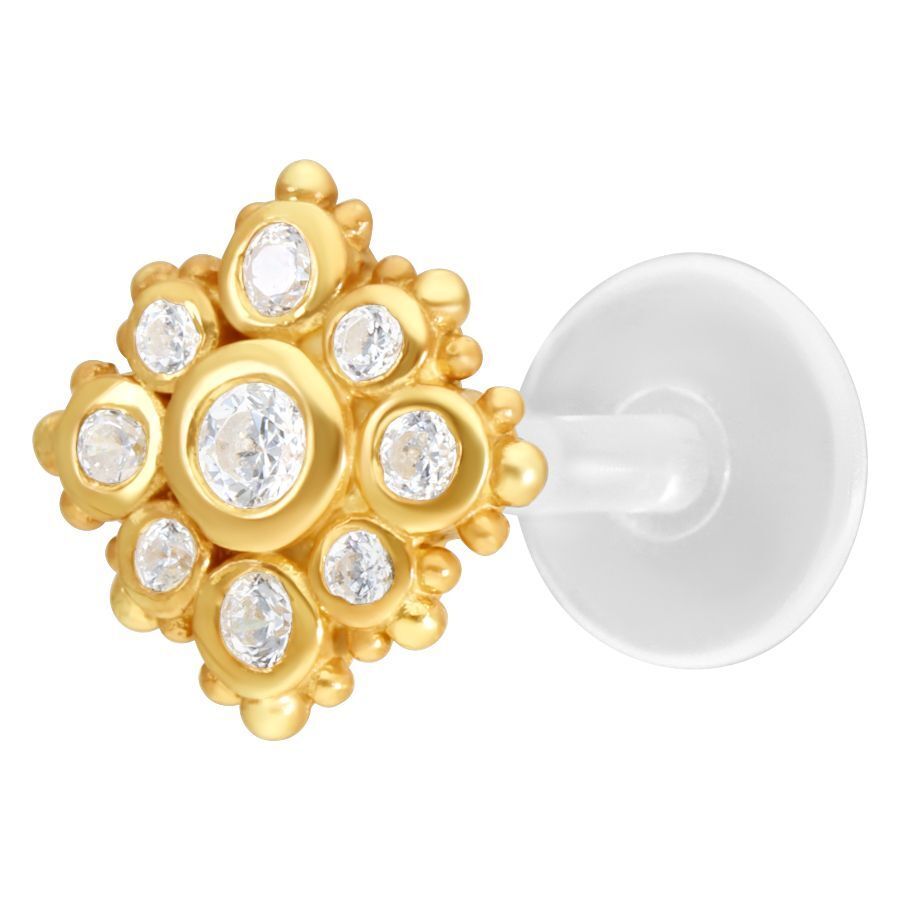 Labret dorado con cristales claros sobre fondo blanco