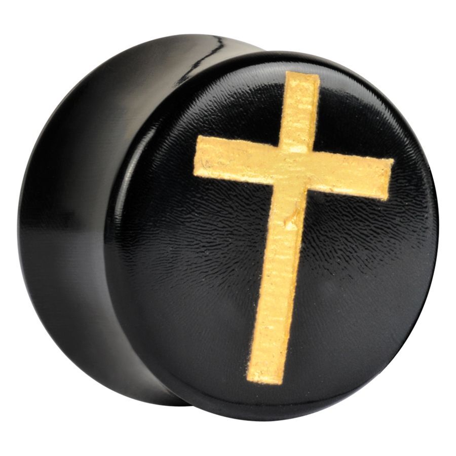 Plug de cuerno negro con cruz dorada sobre superficie brillante