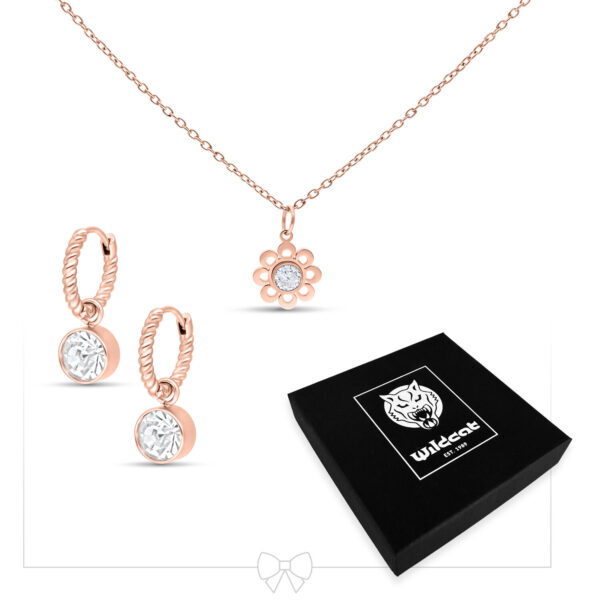 Conjunto de collar y pendientes en oro rosa con colgante de cristal sobre fondo blanco