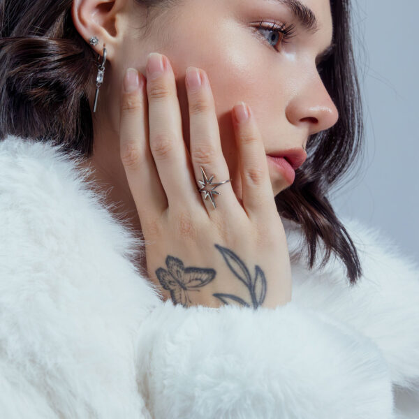 Mujer con anillo Polar Star de acero quirúrgico, primer plano, fondo blanco