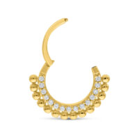 Aro de piercing dorado con pequeñas bolas y cristales claros sobre fondo blanco
