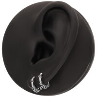 Aros plateados en un modelo de oreja negra, dispuestos en círculo