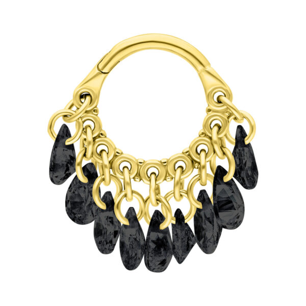 Clicker dorado con cristales negros colgantes sobre fondo blanco