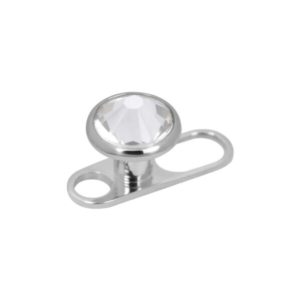 Titan Dermal Anchor plateado con cristal claro sobre fondo blanco