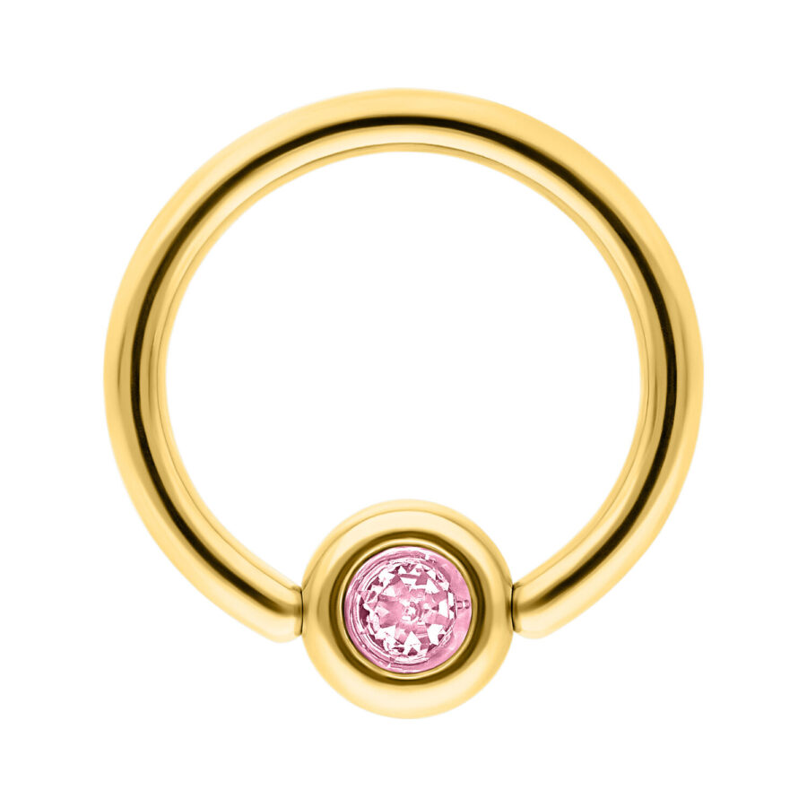 Anillo de piercing dorado con cristal rosa sobre fondo blanco