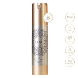 Botella plateada de Radiance Balm con tapa dorada y diseño de mandala