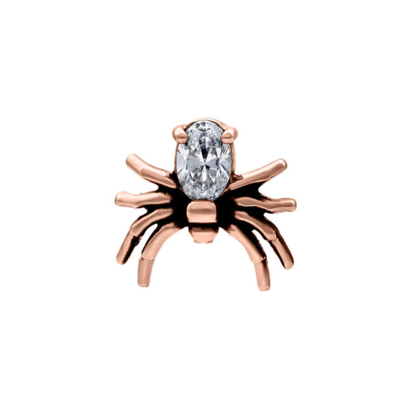 Accesorio de piercing en forma de araña rosado dorado con cristal claro sobre fondo blanco