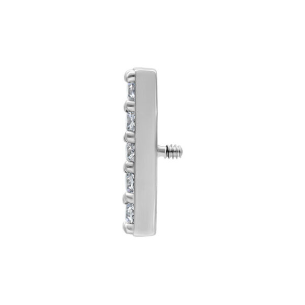 Accesorio de piercing plateado con cristales claros sobre fondo blanco