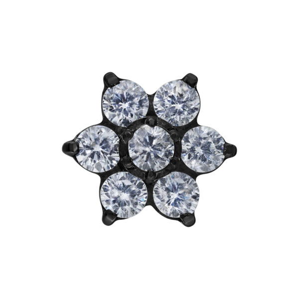 Tapa de flor negra con cristales claros sobre fondo blanco
