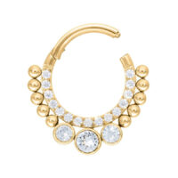 Clicker de septum dorado con cristales, en estado abierto sobre fondo blanco