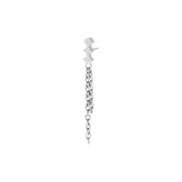 Accesorio de piercing plateado con tres cristales claros y cadenas colgantes sobre fondo blanco