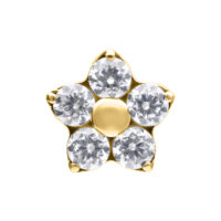Aplique de flor dorado con cinco cristales claros sobre fondo blanco
