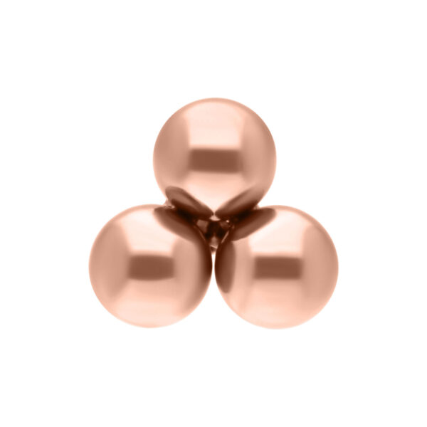 Tres bolas brillantes de titanio en roségold sobre fondo blanco