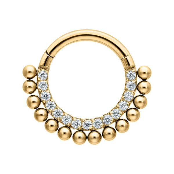 Anillo de piercing dorado con cristales sobre fondo blanco