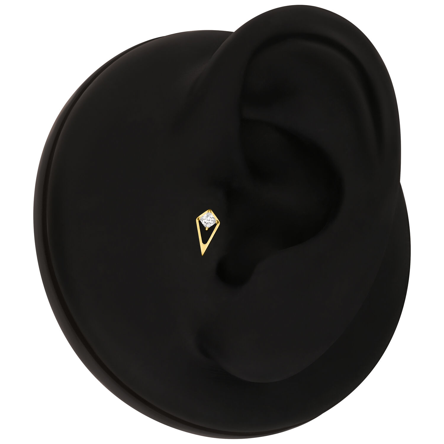 Accesorio de piercing dorado en modelo de oreja negra sobre fondo blanco