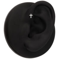 Ajuste de oreja negro con piercing de cruz Modelo de oreja negra con piercing de cruz plateada sobre fondo negro