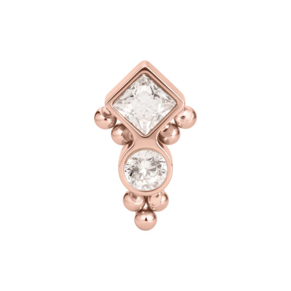 Aplique Push Fit en oro rosa con dos cristales claros y pequeñas burbujas, sobre fondo blanco