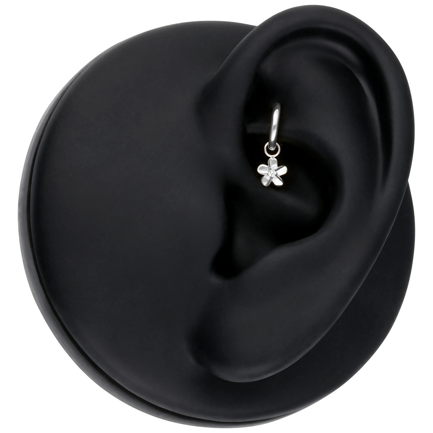 Piercing colgante de flor plateada Colgante de flor plateada en un modelo de oreja negra, primer plano