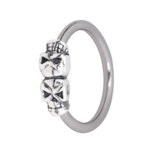 Aro clip in plateado con dos calaveras pequeñas sobre fondo blanco