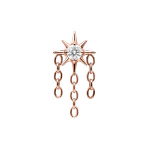 Aplique de estrella en roségold con cristal claro y tres cadenas colgantes sobre fondo blanco