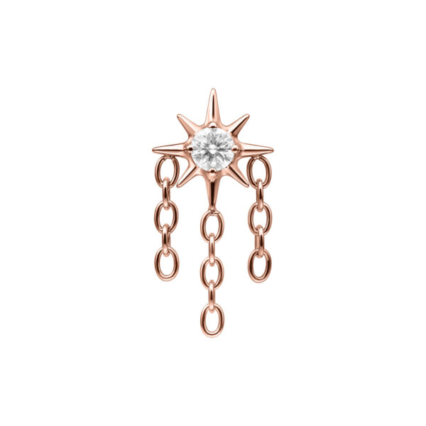 Aplique de estrella en roségold con cristal claro y tres cadenas colgantes sobre fondo blanco
